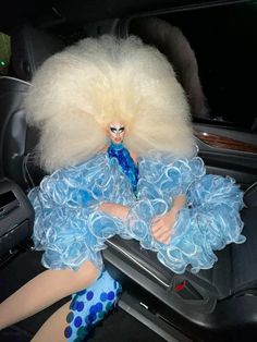 a doll sitting in the back seat of a car
