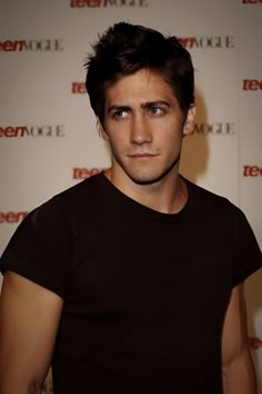 a man in black shirt posing for the camera