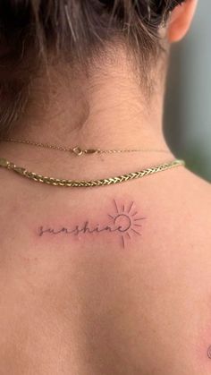 a woman with a sun tattoo on her back