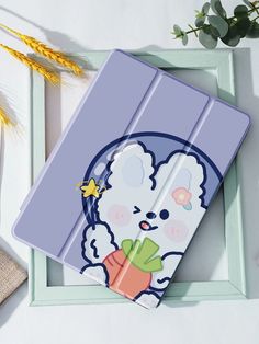 an ipad case with a cartoon bear holding a carrot in it's hand, next to some flowers