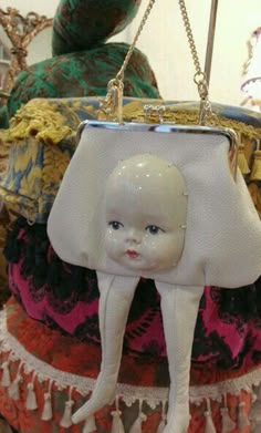 a white purse with a doll on it