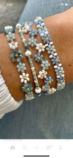 the bracelets are decorated with blue and white flowers on each side of the arm