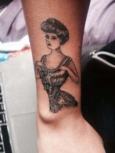 a woman's arm with a tattoo on it that has an image of a woman