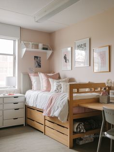 a bedroom with pink walls and white furniture