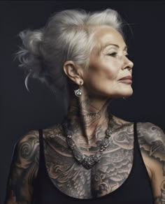 an older woman with tattoos on her neck and chest, looking off to the side