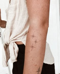 a person with a star tattoo on their arm