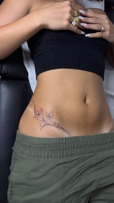 a woman with a tattoo on her stomach