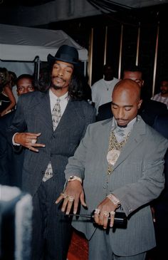 two men standing next to each other in front of a crowd