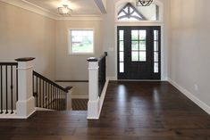 Dark Brown Hickory Hardwood Entryway with Black Door