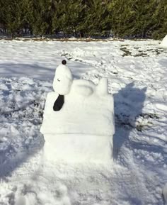 a snowman made to look like a polar bear in the middle of some snow