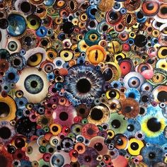 an abstract painting with many different colors and designs on it's surface, including eyeballs