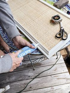 a person is using scissors to trim a table