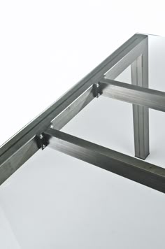 a glass table with metal frame and legs on the bottom, against a white background