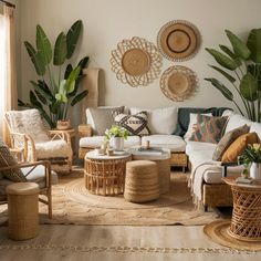 a living room with wicker furniture and large plants on the wall behind it,
