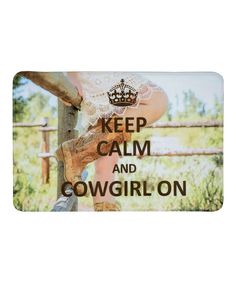 a sign that says keep calm and cowgirl on with a photo of a woman leaning up against a fence
