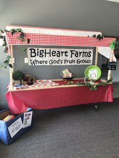 a table with a sign that says, big heart farms where god's fruit grows