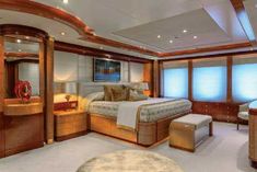 there is a large bed in the middle of this room with windows on both sides