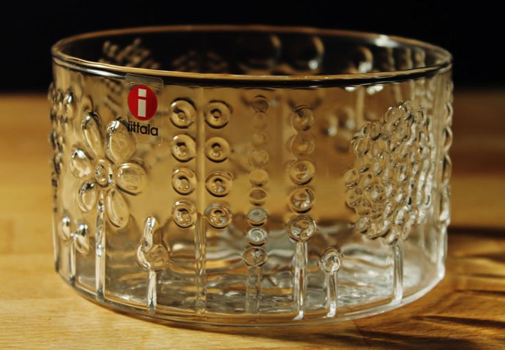 a clear glass cup sitting on top of a wooden table