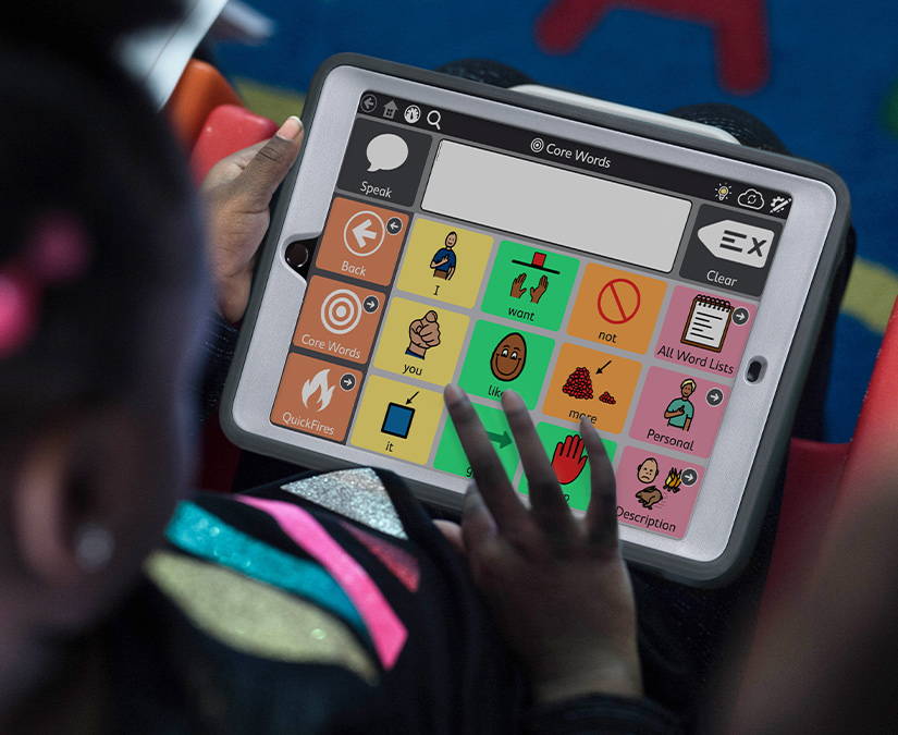 Girl using TD Snap AAC app on a Tobii Dynavox SC Tablet.