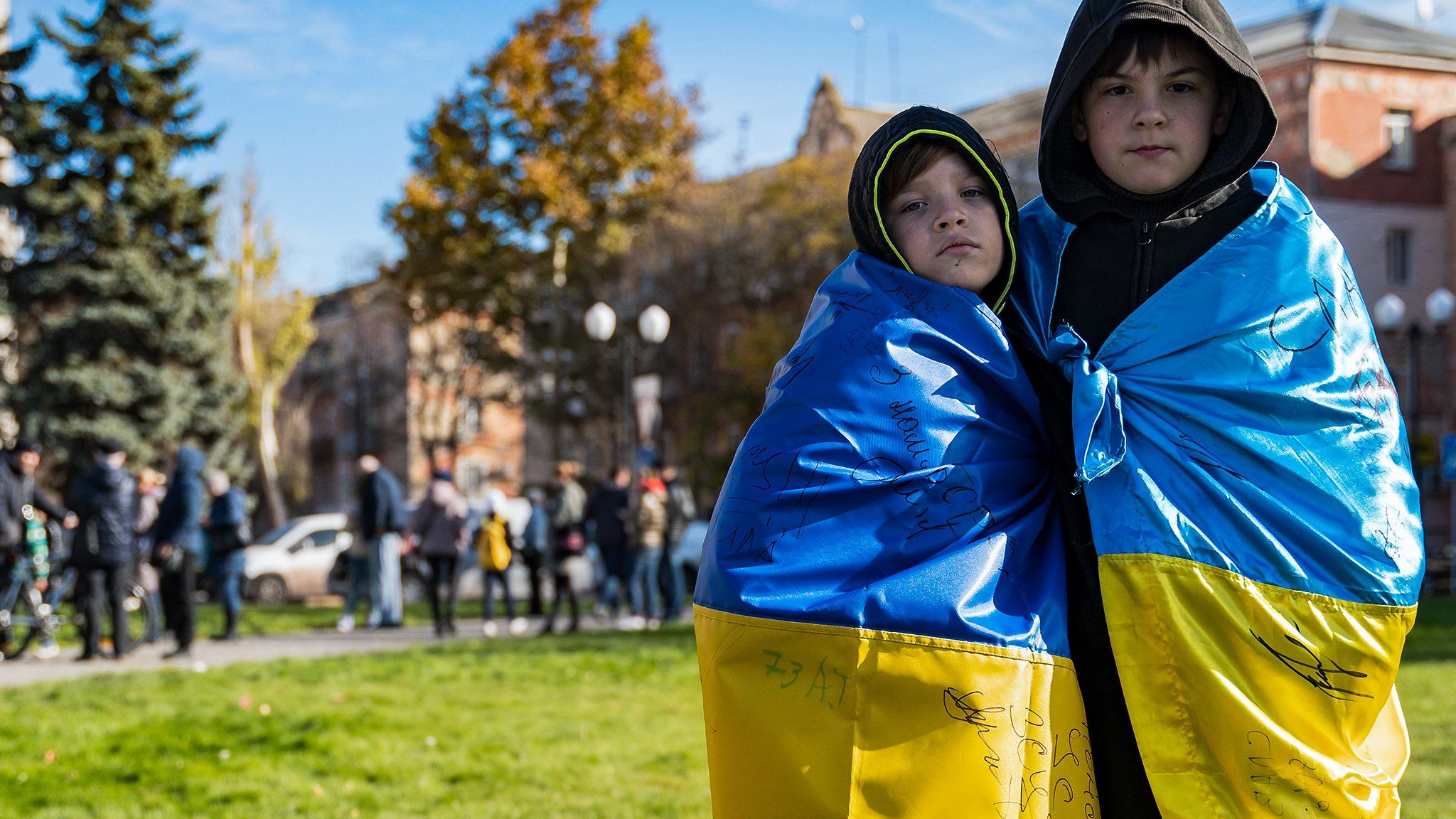 Two boys draped in the Ukrainian flags celebrated last November in Freedom Square following Russia's withdrawal from the city of Kherson.