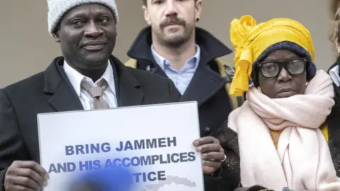 Victims and their relatives demonstrate in front of the Federal Criminal Court of Switzerland before the beginning of the trial against Gambia's former Interior Minister Ousman Sonko in Bellinzona, Switzerland, 08 January 2024.