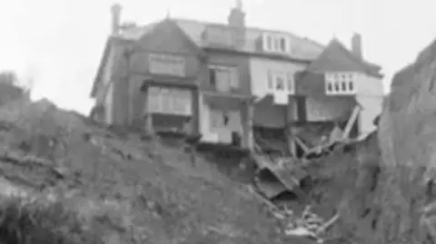 Archive video from 1967 shows a man reluctant to move despite land around his house crumbling.