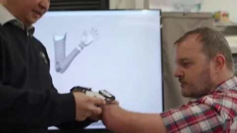 Paul Carter tries out the bionic arm