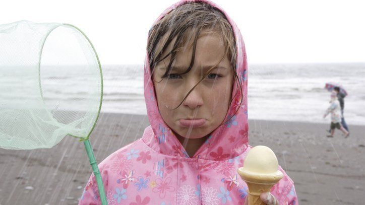 fed-up child in rain