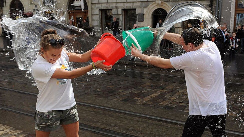 People throwing water on each other.