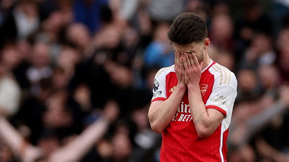 Arsenal's Declan Rice holds his head in his hands after a football match against Aston Villa