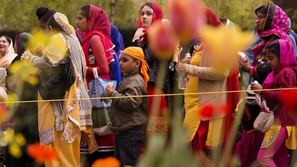 Families watching a Vaisakhi procession