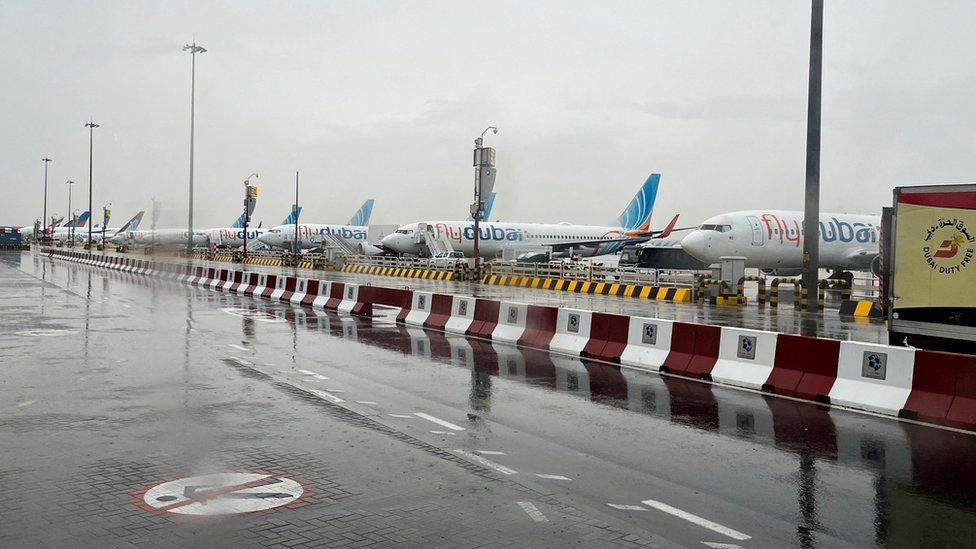 A rainy view at Dubai Airport with planes