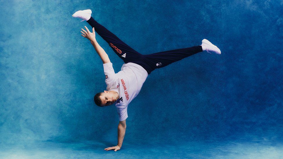 Gymnast Max Whitlock shows off new kit with one handed hand stand.