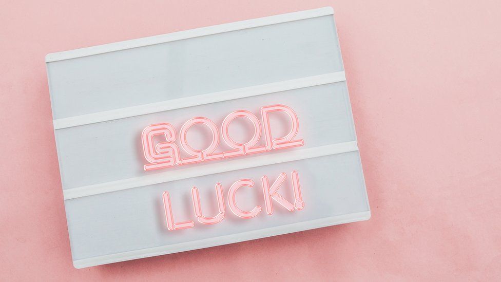 Pink writing saying good luck on a whiteboard
