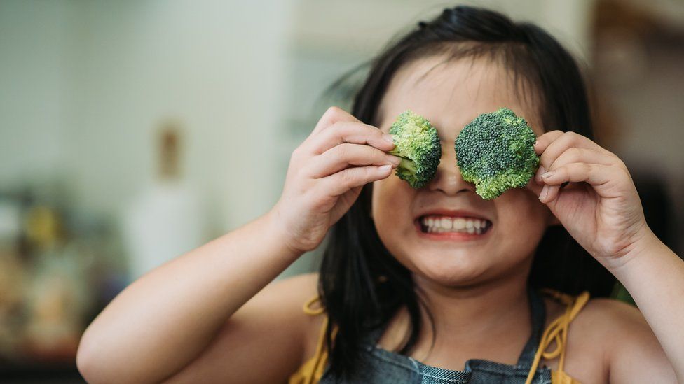 child-with-broccoli over eyes.