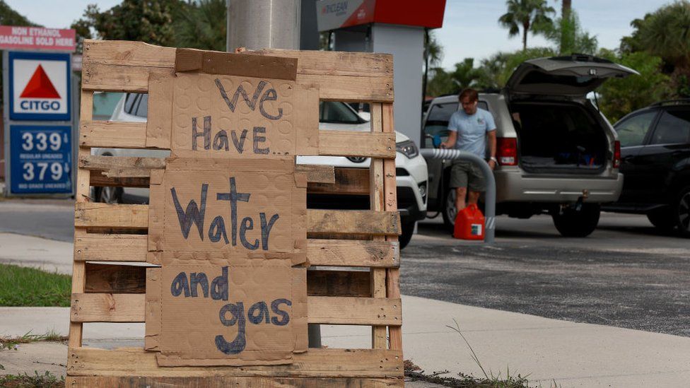 A sign outside of a gas station reads, "we have water and gas" as residents prepare for the possible arrival of Hurricane Ian on September 27, 2022 in St Petersburg Beach, Florida.