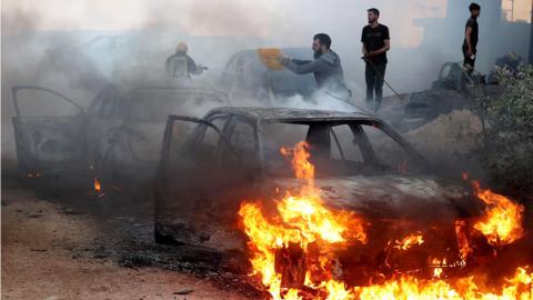 A view of damaged houses and burning vehicles after a raid by Jewish settlers on the Mughir town near Ramallah, West Bank