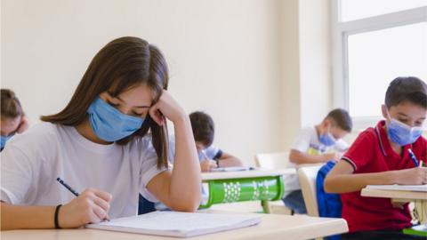 Children wearing masks in classroom