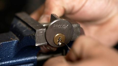 Close up of a locksmith working on a lock