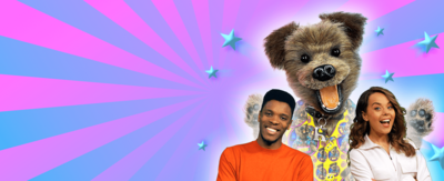 A pink-and-blue background with stars flying out from the centre. Hacker is positioned large and at the back of the image, with Rhys and Evie positioned in front of him, all with a white glow around them.