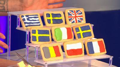 An array of nine iced rectangle biscuits, iced with different European flags.