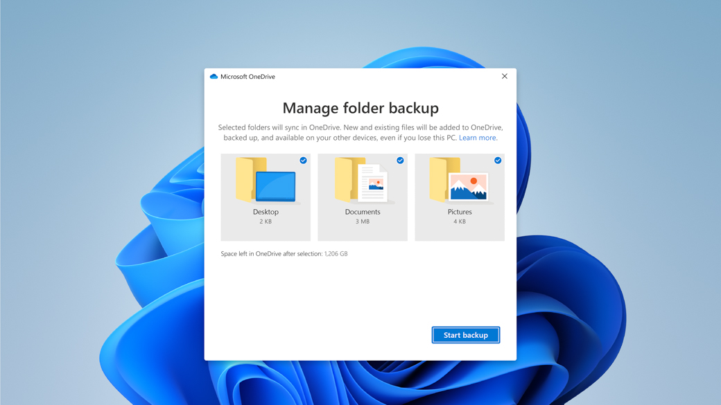Màn hình nền Windows có bông hoa nở rộ với hộp thoại Microsoft OneDrive để quản lý sao lưu thư mục