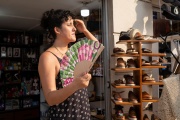 A woman cools off using a fan while standing outside a shoe store in Veracruz, Veracruz state, Mexico on May 24, 2024. 