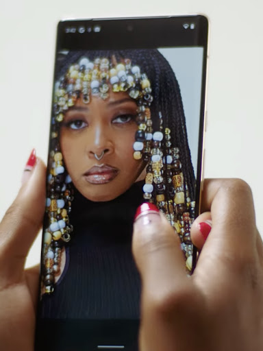 A high quality photo of a Black woman appears on a Pixel phone screen