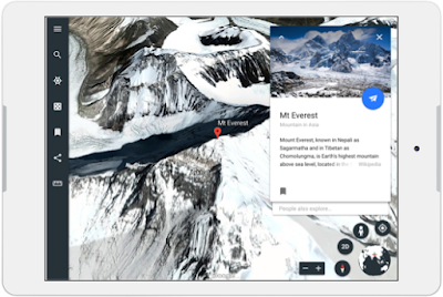A tablet showing an overhead view of snowy mountains from Google Earth.