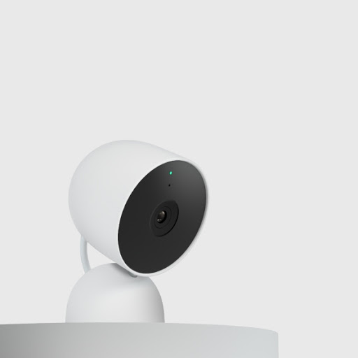 A Nest Cam sits on a shelf in a side profile.