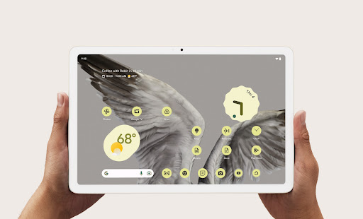 Two hands holding the Pixel Tablet with weather and time shown on front display.