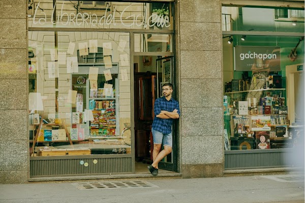 Mattia leans thoughtfully in the doorway to his shop Libreria del Golem