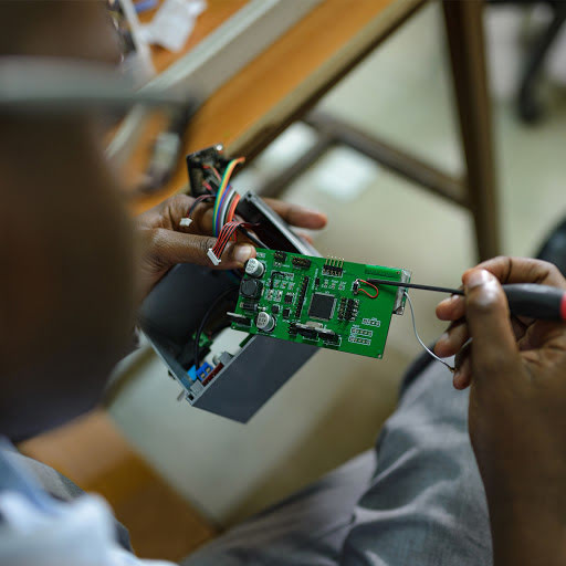 Engineer construye un sensor en su laboratorio de la Universidad de Makerere