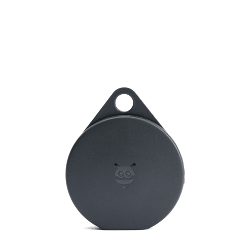 A circular, black Tracking Tag device.